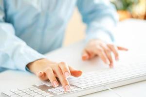 Woman office worker typing on the keyboard photo