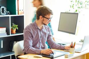 Beautiful young woman and man working from home photo