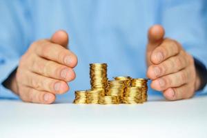Protect new business start-up concept with hands and coin photo