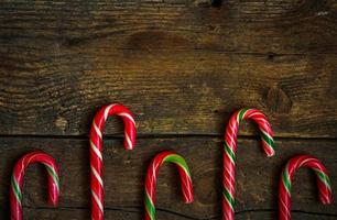 Candy canes on wooden boards photo