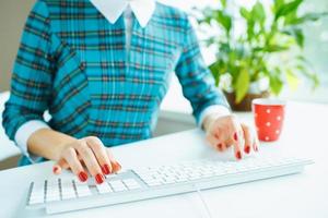 Woman office worker typing on the keyboard photo