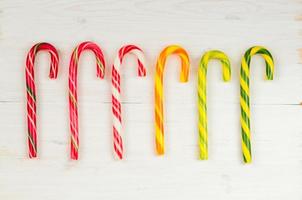 Christmas candy cane on a wooden background photo