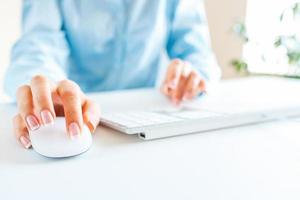 Woman office worker typing on the keyboard photo