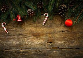 Christmas tree branches with christmas decorations on wooden texture photo