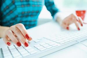 Woman office worker typing on the keyboard photo