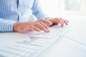 Male hands typing on the keyboard photo