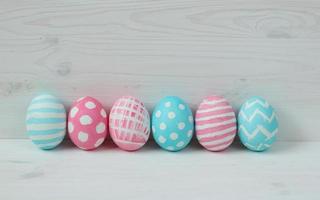 Pink and blue easter eggs on a wooden background photo