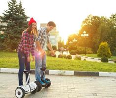 Young couple riding hoverboard photo