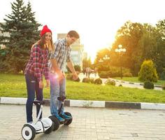 Young couple riding hoverboard photo