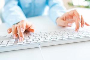 Woman office worker typing on the keyboard photo