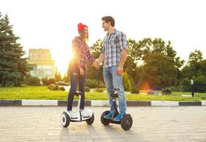 Young couple riding hoverboard photo