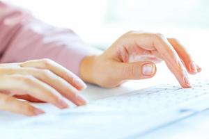 Woman office worker typing on the keyboard photo