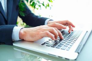 Men office worker typing on the keyboard photo