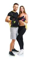 Athletic man and woman after fitness exercise with a thumb up on the white photo