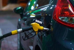 Car refueling on a petrol station at night photo