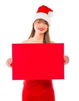 Smiling christmas girl with red placard on white photo