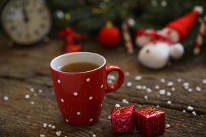 Close up of tea cup with christmas decoration on wooden table photo