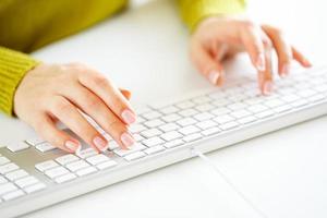 Woman office worker typing on the keyboard photo