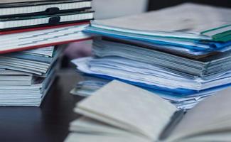 Accounting and taxes. Pile of magazine, notebook and books closeup photo