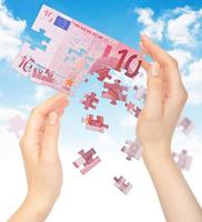 Hands and puzzle out of the money EURO photo