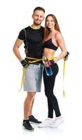 Happy sport couple - man and woman with measuring tape on the white photo