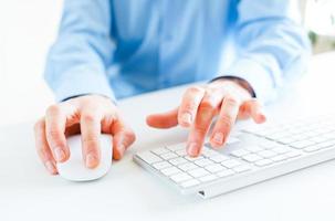 Men office worker typing on the keyboard photo