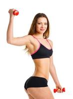 Happy athletic woman with dumbbells doing sport exercise, isolated on white photo