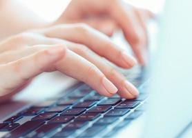 Female woman office worker typing on the keyboard photo