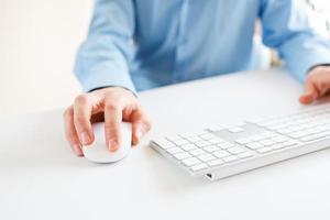 Man office worker typing on the keyboard photo