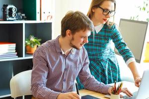 Beautiful young woman and man working from home photo