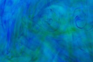 Abstract underwater color background. Color drop underwater creating a silk drapery photo