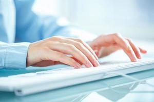 Woman office worker typing on the keyboard photo