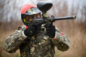 Paintball sport player wearing protective mask photo