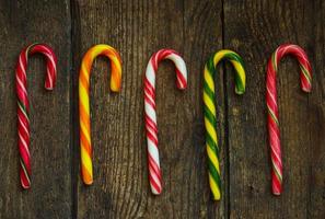 Christmas candy cane on a wooden background photo