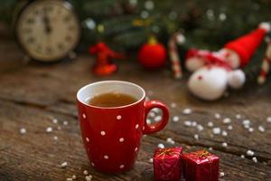 Close up of tea cup with christmas decoration on wooden table photo