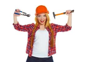 Young woman in helmet with the work tools on a white photo