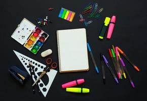 School supplies on blackboard background ready for your design photo