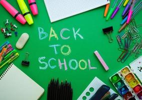 School supplies on blackboard background ready for your design photo