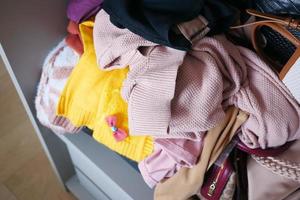 Messy clothes in a drawer at home photo