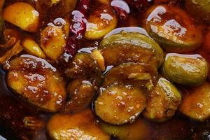 Homemade Mango Pickle in a glass jar on table , photo