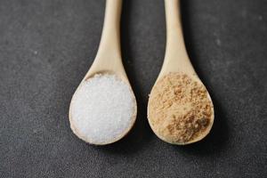 comparing white and brown sugar on spoon photo