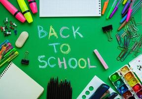 School supplies on blackboard background ready for your design photo
