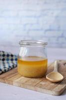 homemade ghee in container on a table , photo