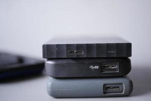 stack of external hard drives on table photo