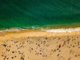 View from above to a busy beach. Coast of the Atlantic Ocean photo