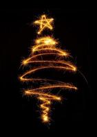 Christmas tree made by sparkler on a black photo