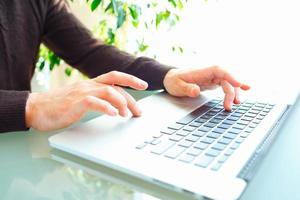 Men office worker typing on the keyboard photo