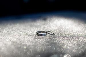 dos hermosa blanco oro Boda anillos en gotas de agua. foto