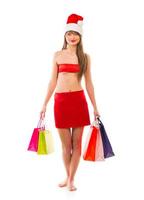 Beautiful Santa christmas girl with shopping bags on white photo