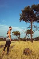 Young stylish handsome man in the savannah photo